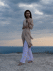 beautiful-woman-coat-posing-beach-fresh-air-elegant-style+copy.gif